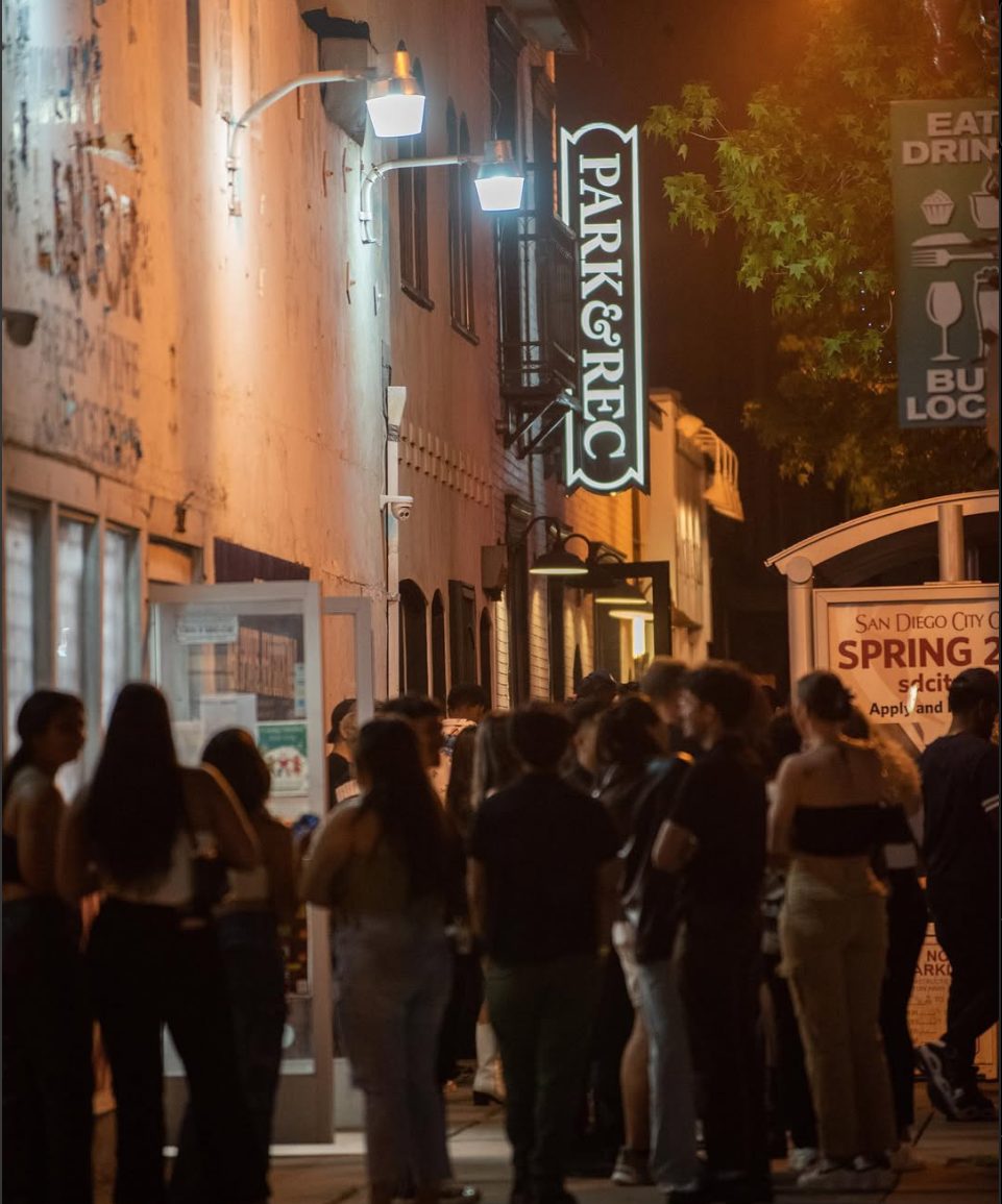Crowd outside a busy bar at night — prime mystery vending territory